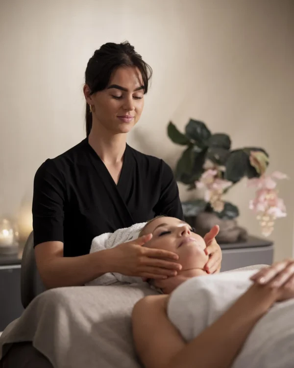 young-woman-massaging-her-client-s-face